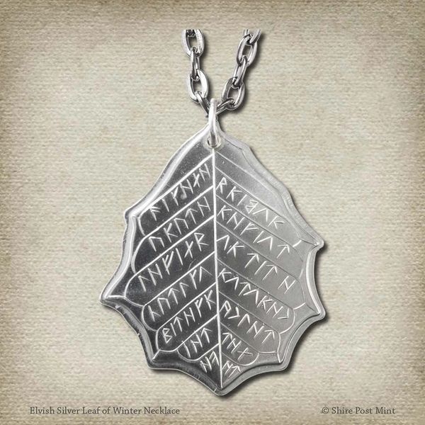 This Elvish Mithril Leaf of Spring Necklace is crafted in celebration of The Lord of the Rings by J. R. R. Tolkien. The leaf-shaped coin is struck from solid silver, measures 2.7 cm in diameter, and weighs about 6.5 grams. Includes a 30" antique bronze cable chain with clasp. Coin artwork by Greg Franck-Weiby. Coins are struck one at a time in the USA using antique machinery and traditional coining techniques. A colorful description is included with history, translations, and facts about the coins.