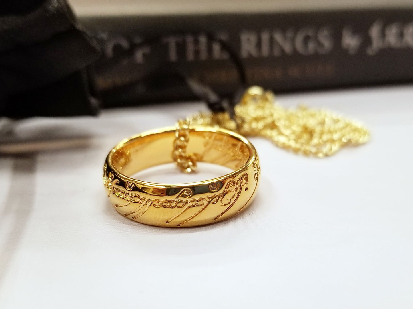 The One Ring, also called The Ruling Ring and Isildur's Bane, is crafted in solid bronze by the Badali Jewelry artists and then barrel plated with pure 24k gold. Each One Ring pendant has the appearance of solid gold, hence the name, Gollum Gold. Our Gollum Gold One Ring appeared in an episode of The Big Bang Theory. 
