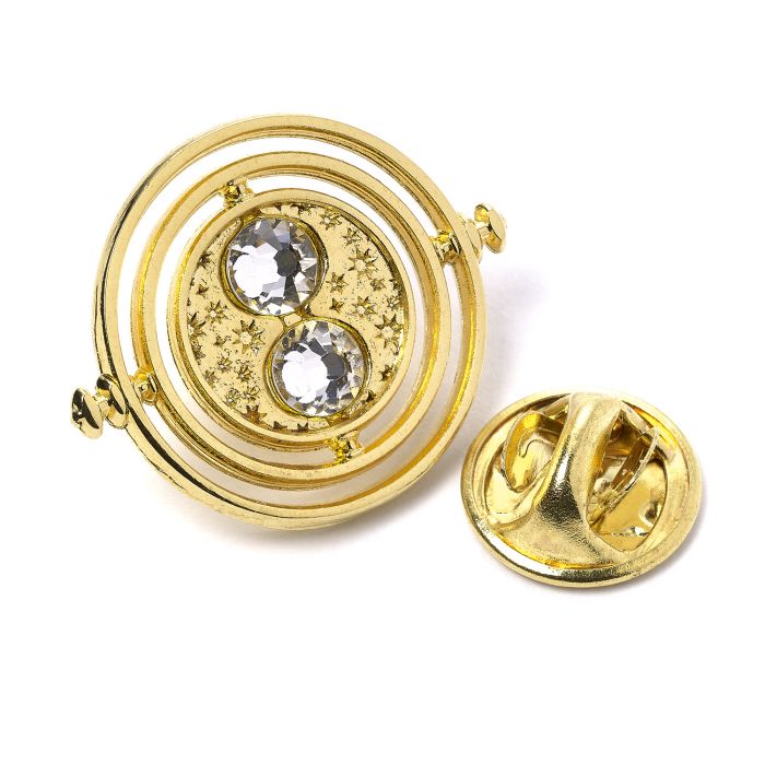 Fixed Time Turner Pin Badge  Worn by Hermione Granger, the Time Turner played a huge part in the Prisoner of Azkaban.  Please be aware that this fixed-pin design does not rotate. This Harry Potter Pin Badge has been created using the official style guide from Warner Bros.  Pin Details:  Around .75" tall and .5" wide (20mm x 16mm) Beautiful gold tone fixed-pin Time Turner with faux crystal bead detail Pin arrives on a printed Harry Potter card backer Quality metal badge pin with butterfly clutch backing  