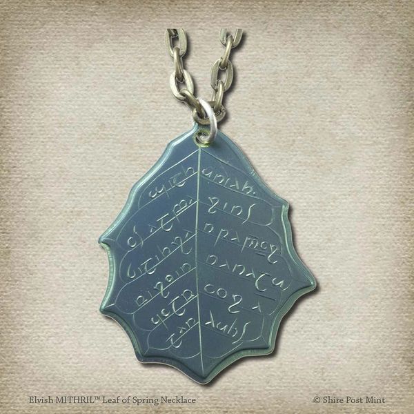 This Elvish Mithril Leaf of Spring Necklace is crafted in celebration of The Lord of the Rings by J. R. R. Tolkien. The leaf-shaped coin is struck from solid niobium, measures 2.7 cm in diameter, and weighs about 6.5 grams. Includes a 30" antique bronze cable chain with clasp. Coin artwork by Greg Franck-Weiby.  Coins are struck one at a time in the USA using antique machinery and traditional coining techniques. A colorful description is included with history, translations, and facts about the coins.