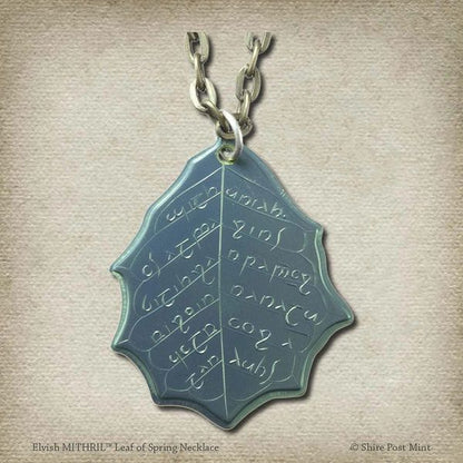 This Elvish Mithril Leaf of Spring Necklace is crafted in celebration of The Lord of the Rings by J. R. R. Tolkien. The leaf-shaped coin is struck from solid niobium, measures 2.7 cm in diameter, and weighs about 6.5 grams. Includes a 30" antique bronze cable chain with clasp. Coin artwork by Greg Franck-Weiby.  Coins are struck one at a time in the USA using antique machinery and traditional coining techniques. A colorful description is included with history, translations, and facts about the coins.