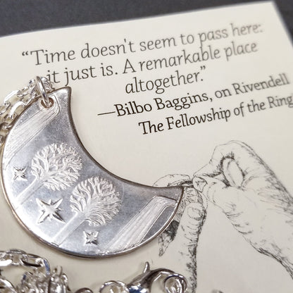 Elvish coin from Rivendell is shaped like a crescent moon. It depicts the valley containing the ancient trees of silver and gold and the three Silmarils, represented as stars. The text in Tengwar translates from Sindarin to Elrond Peredhil, Lord of Rivendell, The Last Homely House East of the Sea. It includes the date that Thorin and Company meet Elrond at Rivendell before continuing on to The Lonely Mountain.  This Rivendell Moon is crafted in celebration of The Lord of the Rings by J. R. R. Tolkien